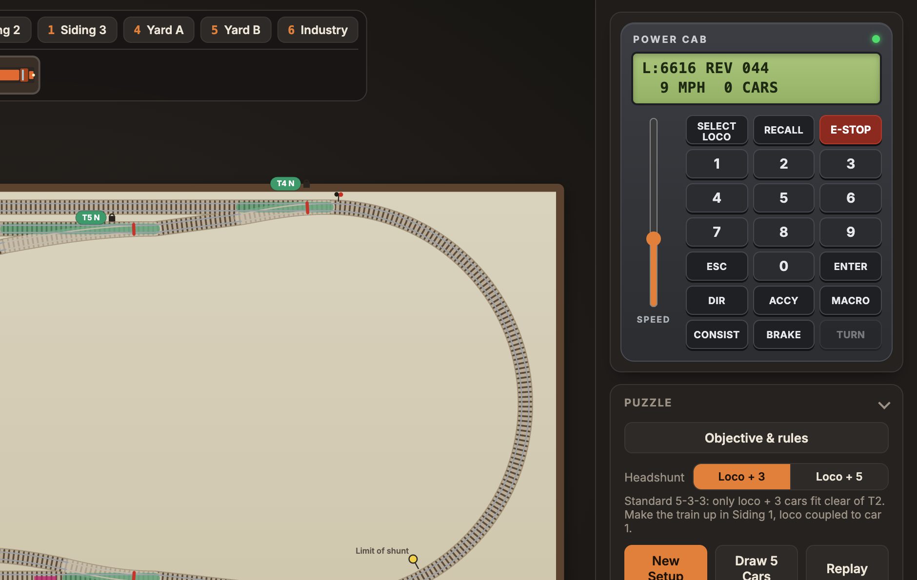 The Power Cab throttle beside the layout, with its green display showing the loco number, direction and speed.